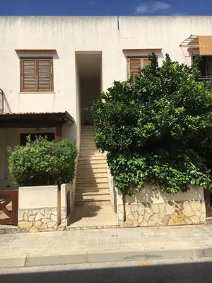 a house with a staircase leading up to a building at Casa Irene in San Vito lo Capo