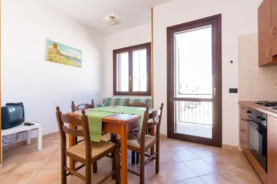 a kitchen and dining room with a table and chairs at Casa Irene in San Vito lo Capo
