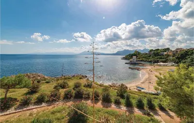 a view of a beach and the ocean at Villa Kericia in Porticello