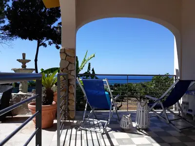 a patio with chairs and a view of the ocean at Villa Belvedere Michelle in Trappeto