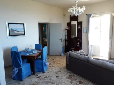 a living room with a couch and a table at Villa Belvedere Michelle in Trappeto