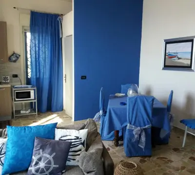 a living room with blue walls and a couch at Villa Belvedere Michelle in Trappeto