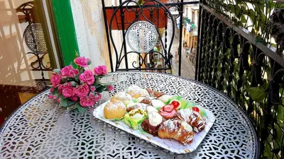 a plate of food sitting on top of a table at Grazioso appartamento nel cuore di Palermo in Palermo