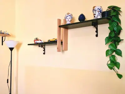 a shelf on a wall with toys and a plant at Grazioso appartamento nel cuore di Palermo in Palermo