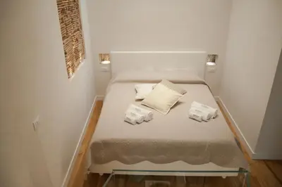 a small bed in a small room with white walls at Petrosino in Palermo