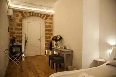 a room with a bed and a desk and a table at Petrosino in Palermo