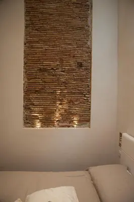 a window in a bedroom with a brick wall at Petrosino in Palermo