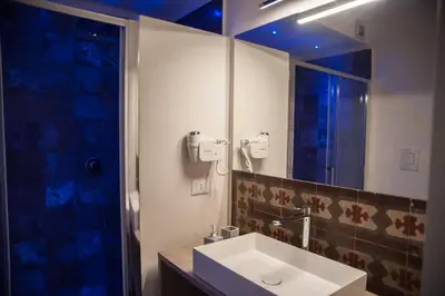 a bathroom with a sink and a mirror and a shower at Petrosino in Palermo