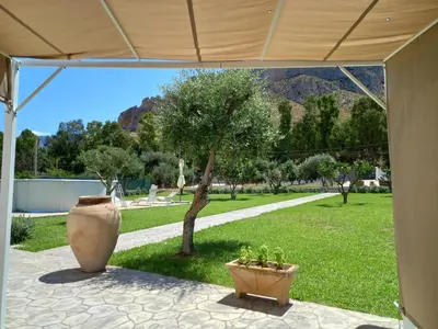 a patio with two large vases sitting under a tent at Villa Eagle in Terrasini