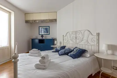 a bedroom with a white bed with towels on it at Terrazze di San Francesco by Wonderful Italy in Palermo