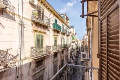 a view of an alley between buildings with balconies at Terrazze di San Francesco by Wonderful Italy in Palermo