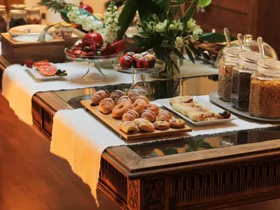 a buffet with different types of pastries on a table at L' Hôtellerie Easy Suites in Palermo