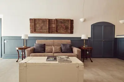 a living room with a couch and a coffee table at L' Hôtellerie Easy Suites in Palermo