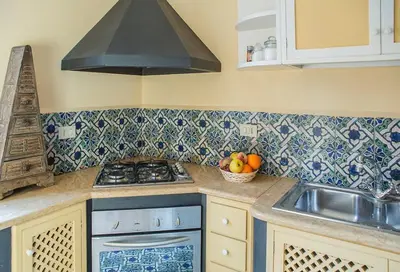 a kitchen with a stove and a bowl of fruit at Kalsa Casa di Charme con terrazza by Wonderful Italy in Palermo