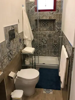 a bathroom with a toilet and a shower at Grace's Place in Scopello