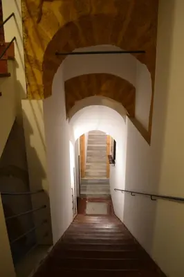 a hallway in a building with an archway at Palazzo Torre Apartment in Palermo