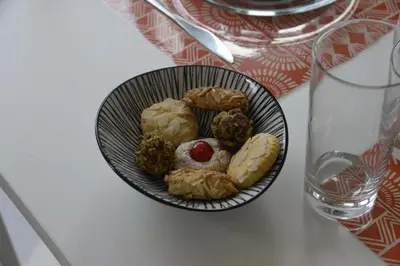 a bowl of pastries on a table next to a glass at Palazzo Torre Apartment in Palermo