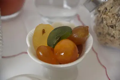 a white bowl filled with fruits and vegetables on a table at Palazzo Torre Apartment in Palermo