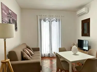 a living room with a couch and a table at Appartamenti-Residence Al Massimo in Palermo