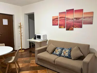 a living room with a couch and a table at Appartamenti-Residence Al Massimo in Palermo