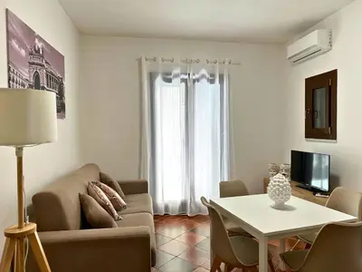 a living room with a couch and a table at Appartamenti-Residence Al Massimo in Palermo