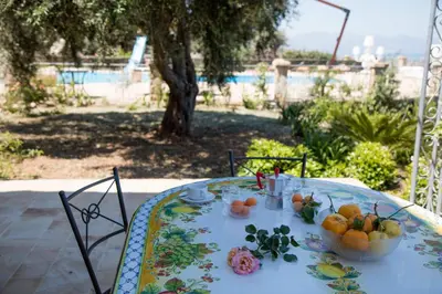 a table with a bowl of fruit on it at Terrazze sul Tirreno in Lascari