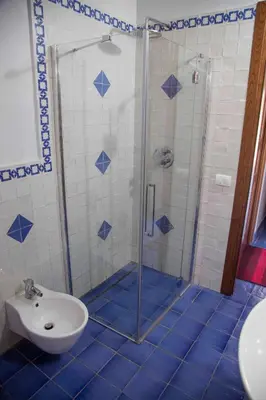 a bathroom with a shower and a toilet and a sink at Terrazze sul Tirreno in Lascari