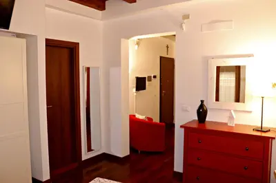 a living room with a red dresser and a mirror at La Casetta di Clara in Palermo