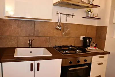 a kitchen with a sink and a stove at La Casetta di Clara in Palermo