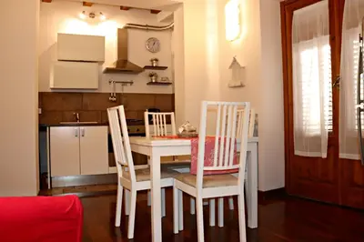 a kitchen with a table and chairs in a room at La Casetta di Clara in Palermo