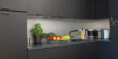 a kitchen with a sink with fruit in a bowl at Alla Corte Maqueda in Palermo