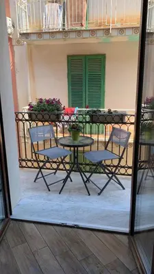 a patio with a table and chairs on a balcony at B&B Cinisi Vacanze 2.0 in Cinisi