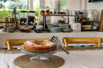 a dining room with a table and a clock on the wall at Grotta dei Puntali B&B in Carini