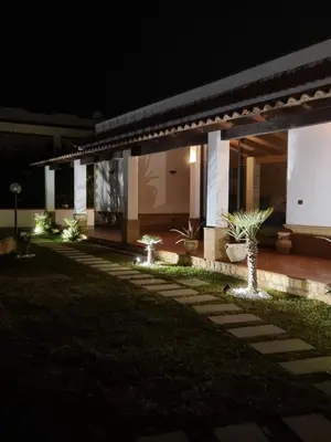a building with lights in front of it at night at Villa Sunshine in Balestrate
