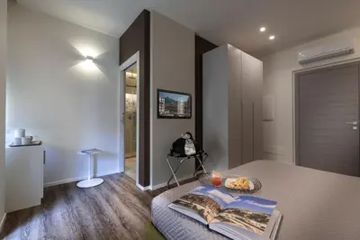 a bedroom with a bed with a table and a door at B&B In Centro Palermo in Palermo