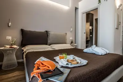 a bed with a tray of food on it at B&B In Centro Palermo in Palermo