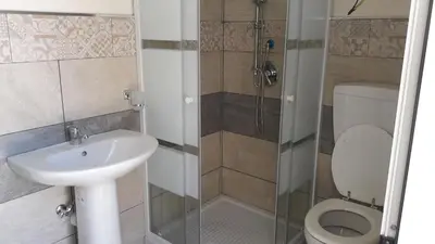 a bathroom with a toilet and a sink and a shower at Casa Vacanze Reginotte in Balestrate