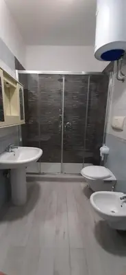 a bathroom with two sinks and a shower and two toilets at Villa Pinella in Palermo