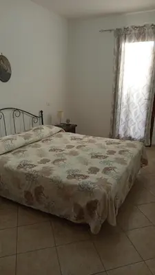 a bedroom with a bed and a window at Appartamento Nino in San Vito lo Capo