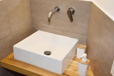 a bathroom with a white sink on a counter at 315 Via Roma Rooms centro in Palermo