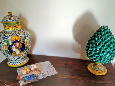 two vases sitting on a wooden table next to a vase at Summer Dream LA CASA SUL MARE in Trappeto