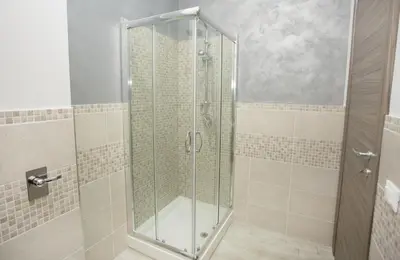 a shower with a glass door in a bathroom at B&B Palermo Sole & Cultura in Palermo