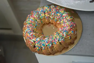 a donut with sprinkles sitting on a plate at B&B Palermo Sole & Cultura in Palermo