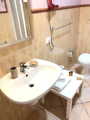 a bathroom with a white sink and a toilet at B&B Dimora Annulina in Palermo