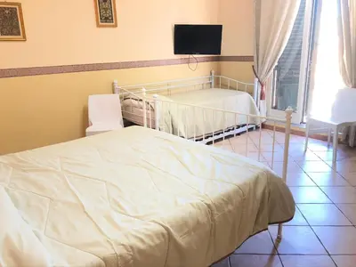 a bedroom with a bed and a flat screen tv at B&B Dimora Annulina in Palermo