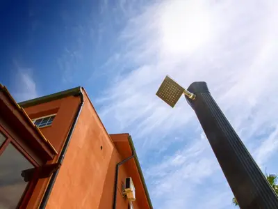 a street light on a pole next to a building at Gelso Bianco Apartments in Campofelice di Roccella