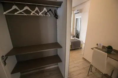 a walk in closet with hangers in a room at Casantò guest home in Palermo