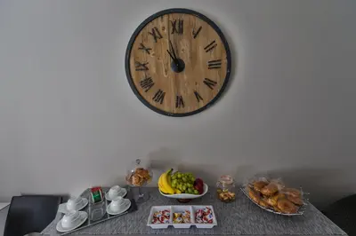 a table with a clock on the wall and food on it at Casantò guest home in Palermo