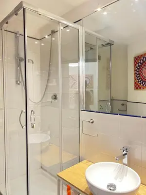 a bathroom with a glass shower and a sink at COLORI di PALERMO in Palermo