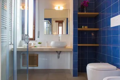 a bathroom with a sink and a toilet and a mirror at Mondello Martini in Mondello